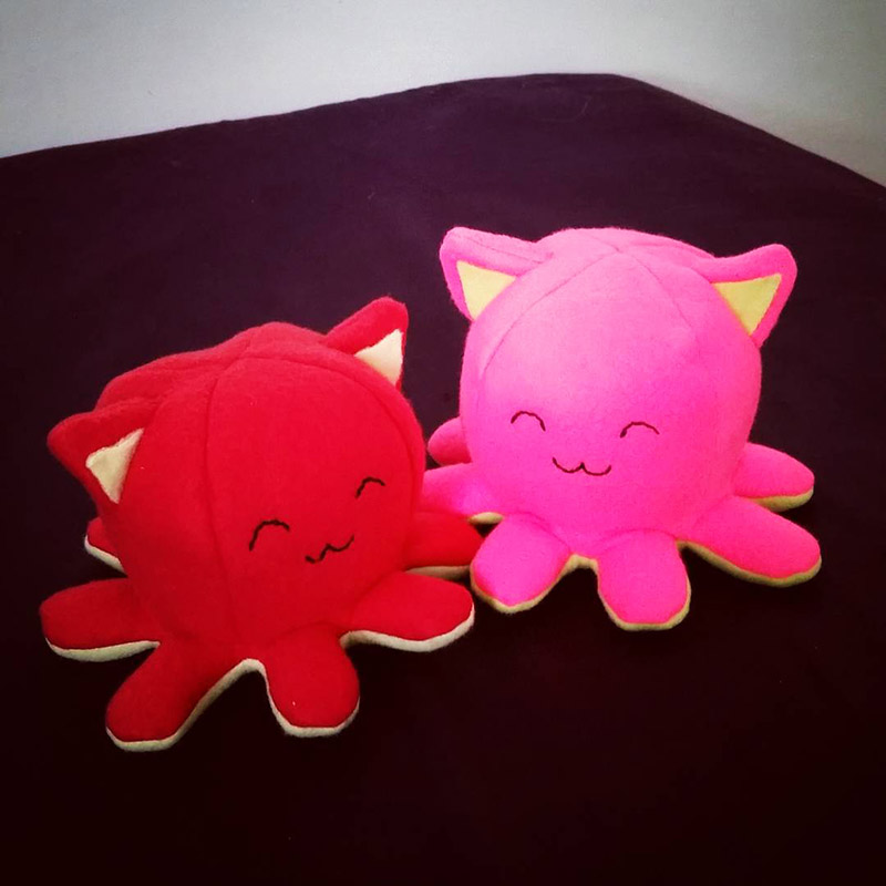 a red and a bright pink Taneko the Octo-puss duo of plush toys