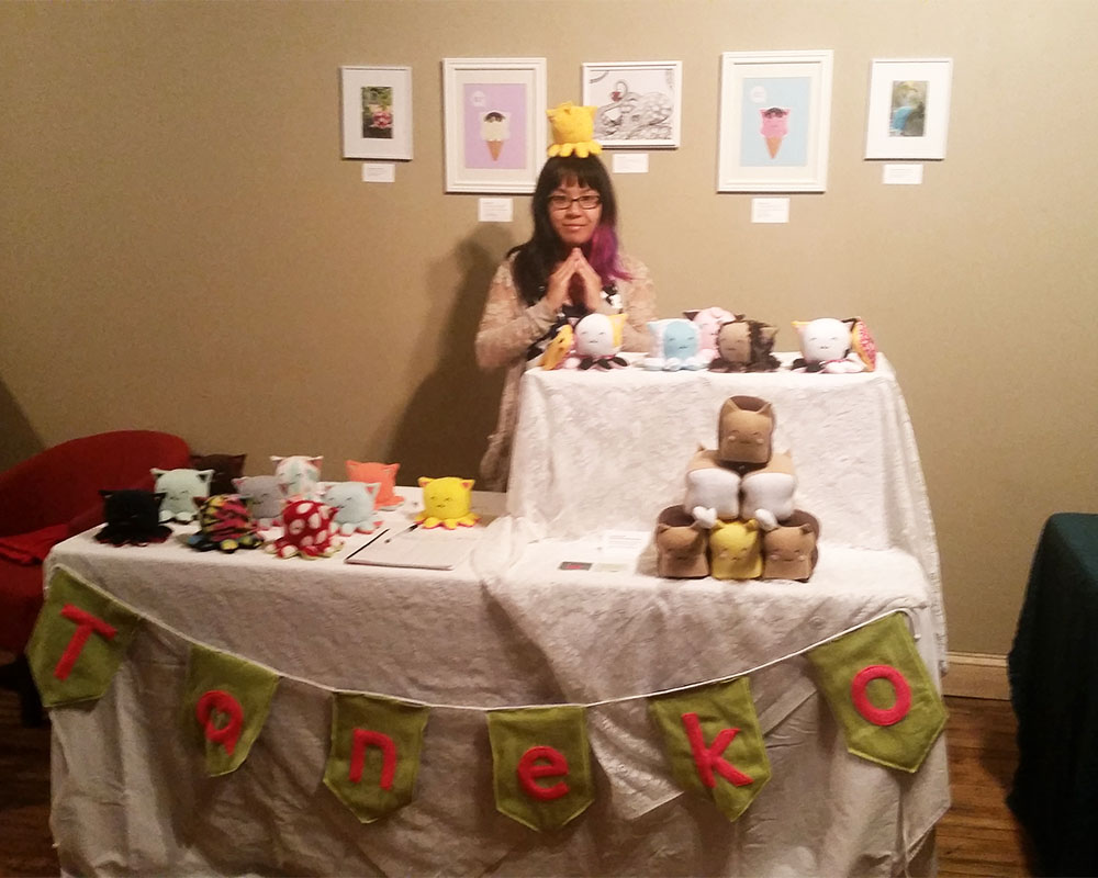 Taneko Says Hello table booth display at Catzilla