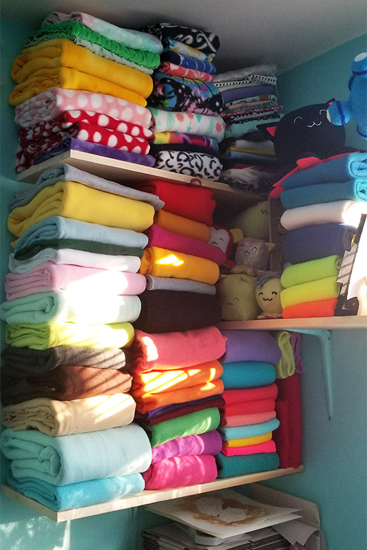 stacks of colorful fleece on fabric shelves