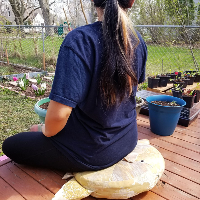 girl sitting outside on Sunfish zafu cushion