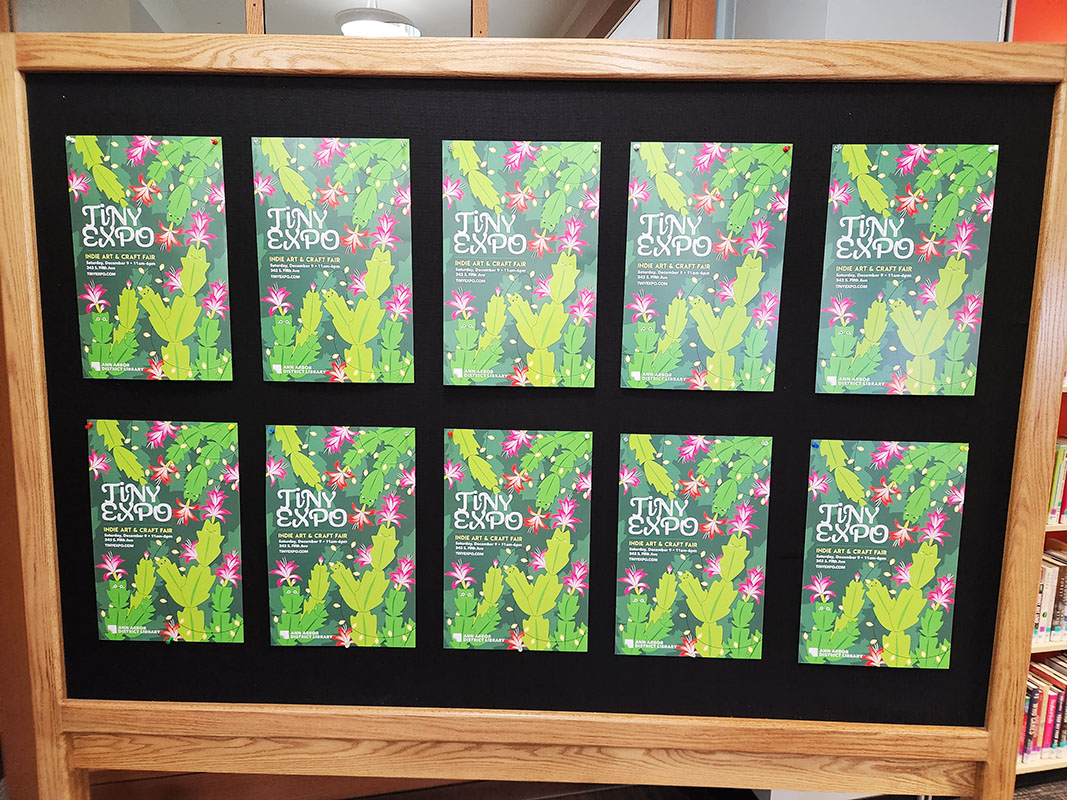 blackboard with 10 Tiny Expo event posters designed by Taneko Says Hello