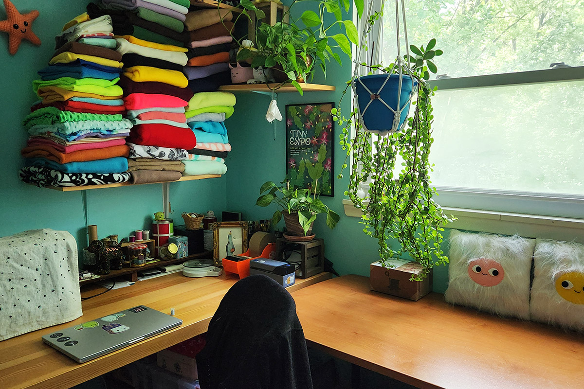 sewing studio with colorful fabric shelves