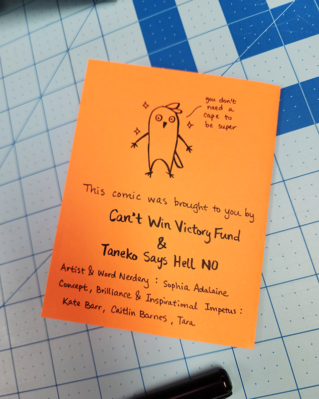 orange back cover for a comic book collaboration between Can't Win Victory Fund and Taneko Says Hell No