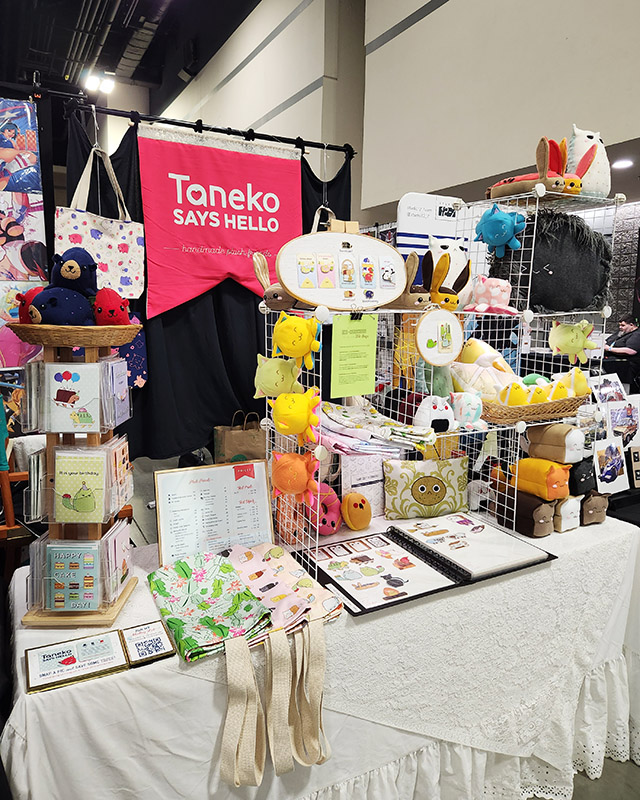 Taneko Says Hello table booth display at Heroes Con