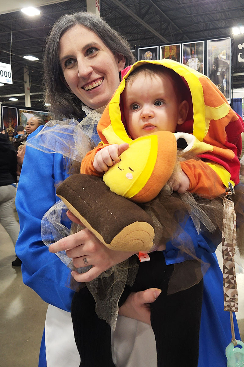 mother and baby cosplaying as Sophie and Calcifer from Howl's Moving Castle holding Happy Campfire plushie
