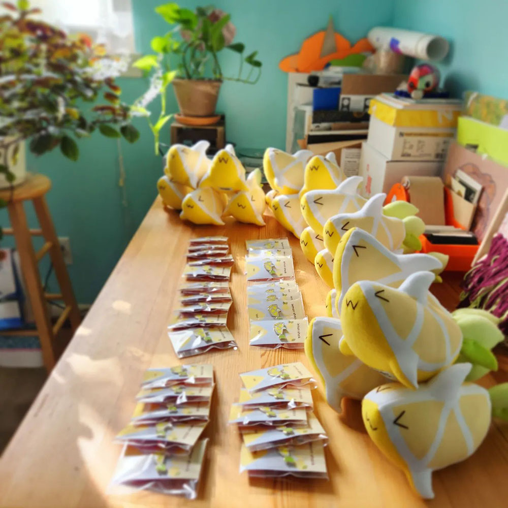 Wholesale enamel pins and handmade Baby Lemon Shark plush toys by Taneko Says Hello for Sharks4Kids