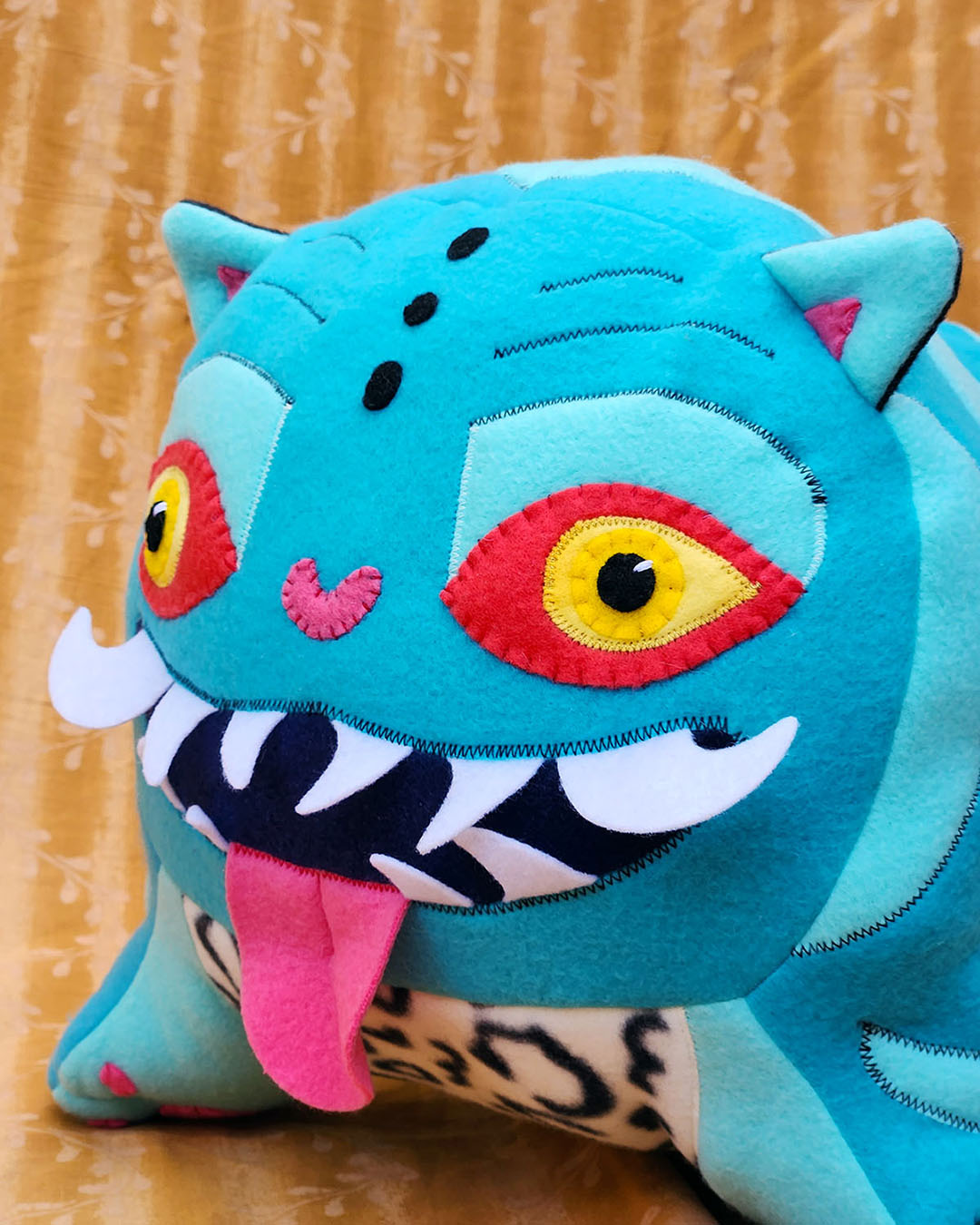Derpy the Tiger from Kpop Demon Hunters, detail of face // soft sculpture art by Sophia Adalaine